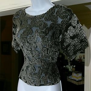Cache ladies top.that is see through and covered